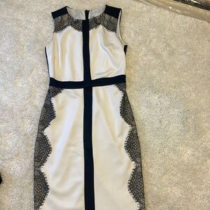 White sleeveless dress with black lace accents. Worn once.